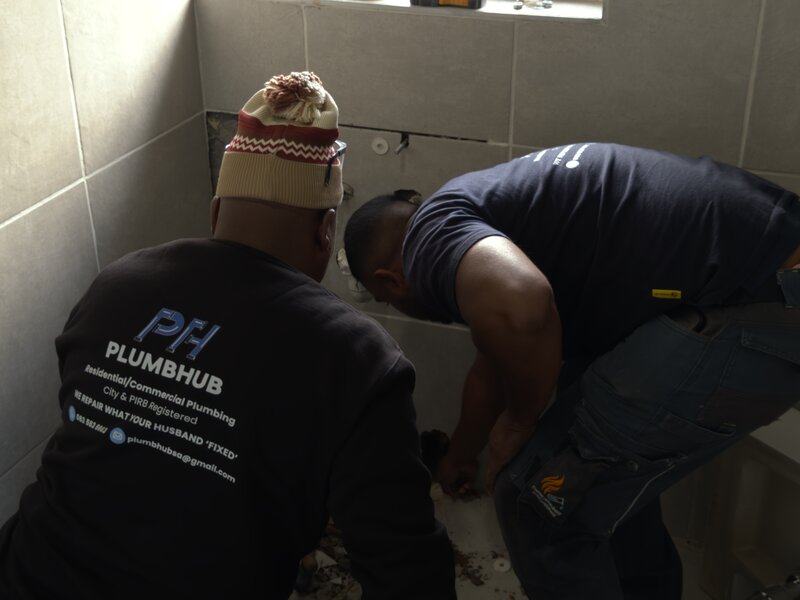 Plumbhub plumbers at work in a bathroom